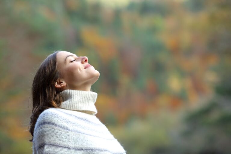 woman smiling as she breathes through nose